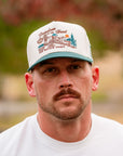 Close-up of The Mallard II Hat featuring embroidered flying mallard and rugged landscape