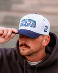 Close-up of The Big Bow Hat featuring embroidered rainbow trout and water detail