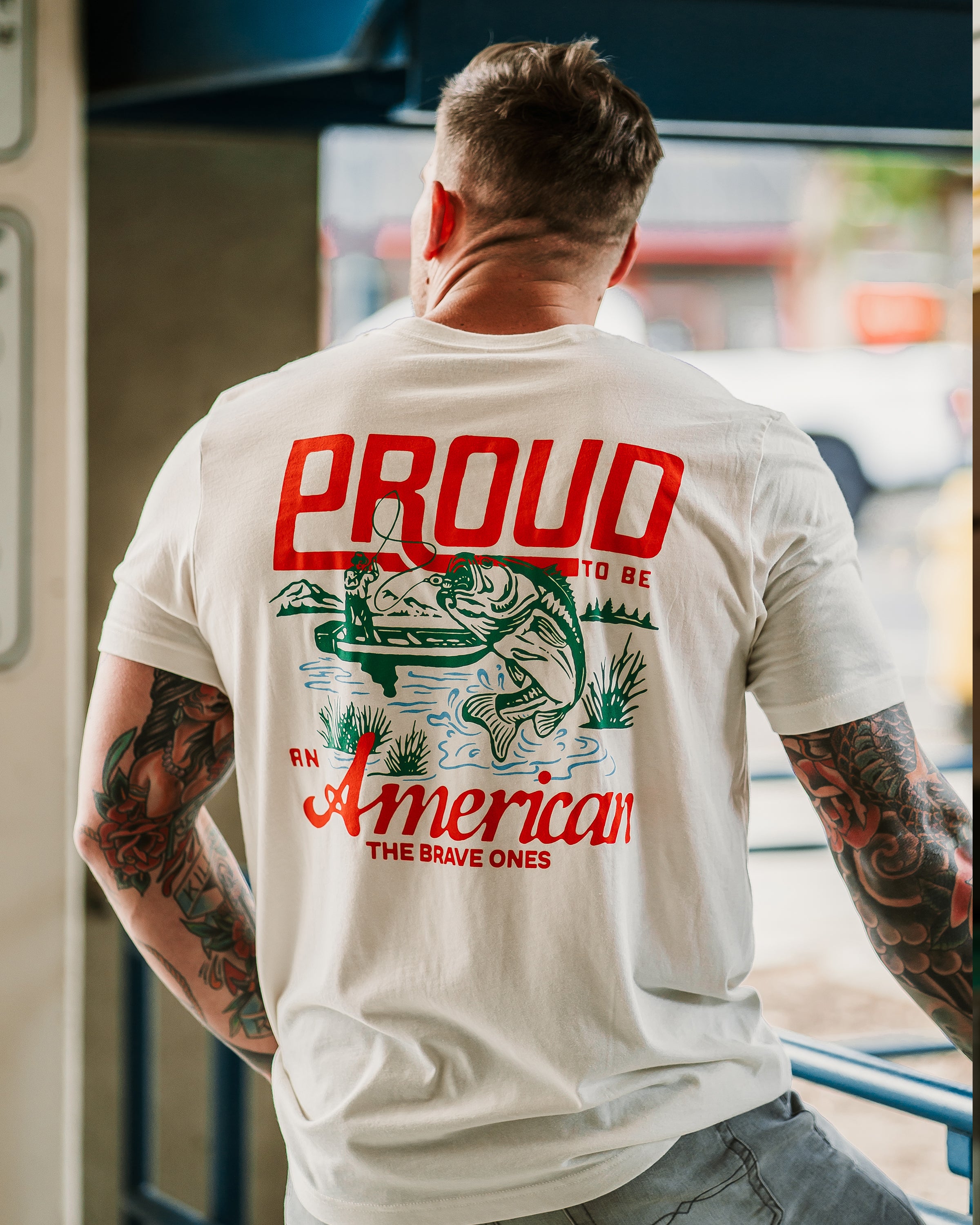 Proud American Fisherman T-shirt by The Brave Ones – Vintage white fishing tee with patriotic largemouth bass graphic