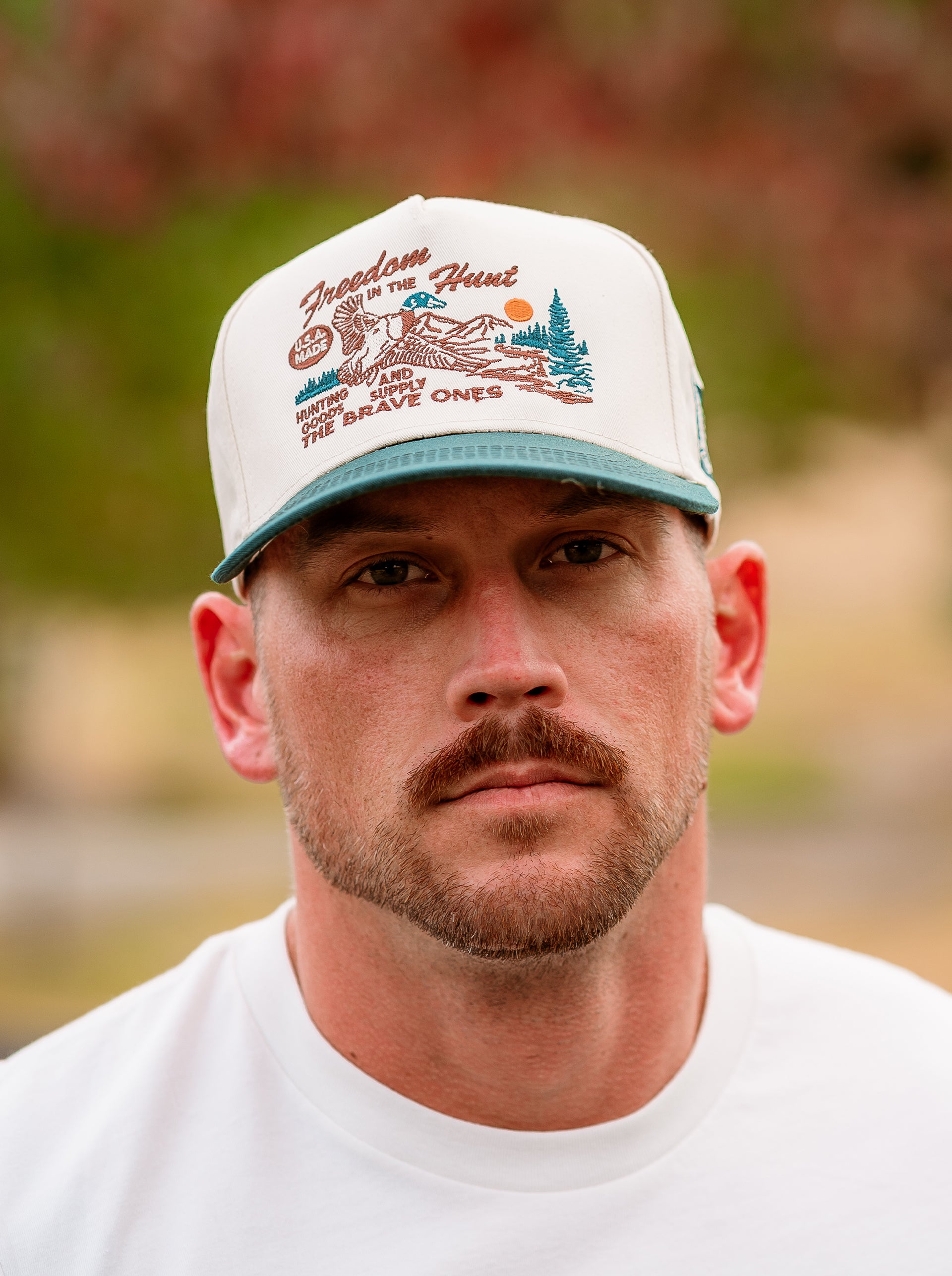 Close-up of The Mallard II Hat featuring embroidered flying mallard and rugged landscape